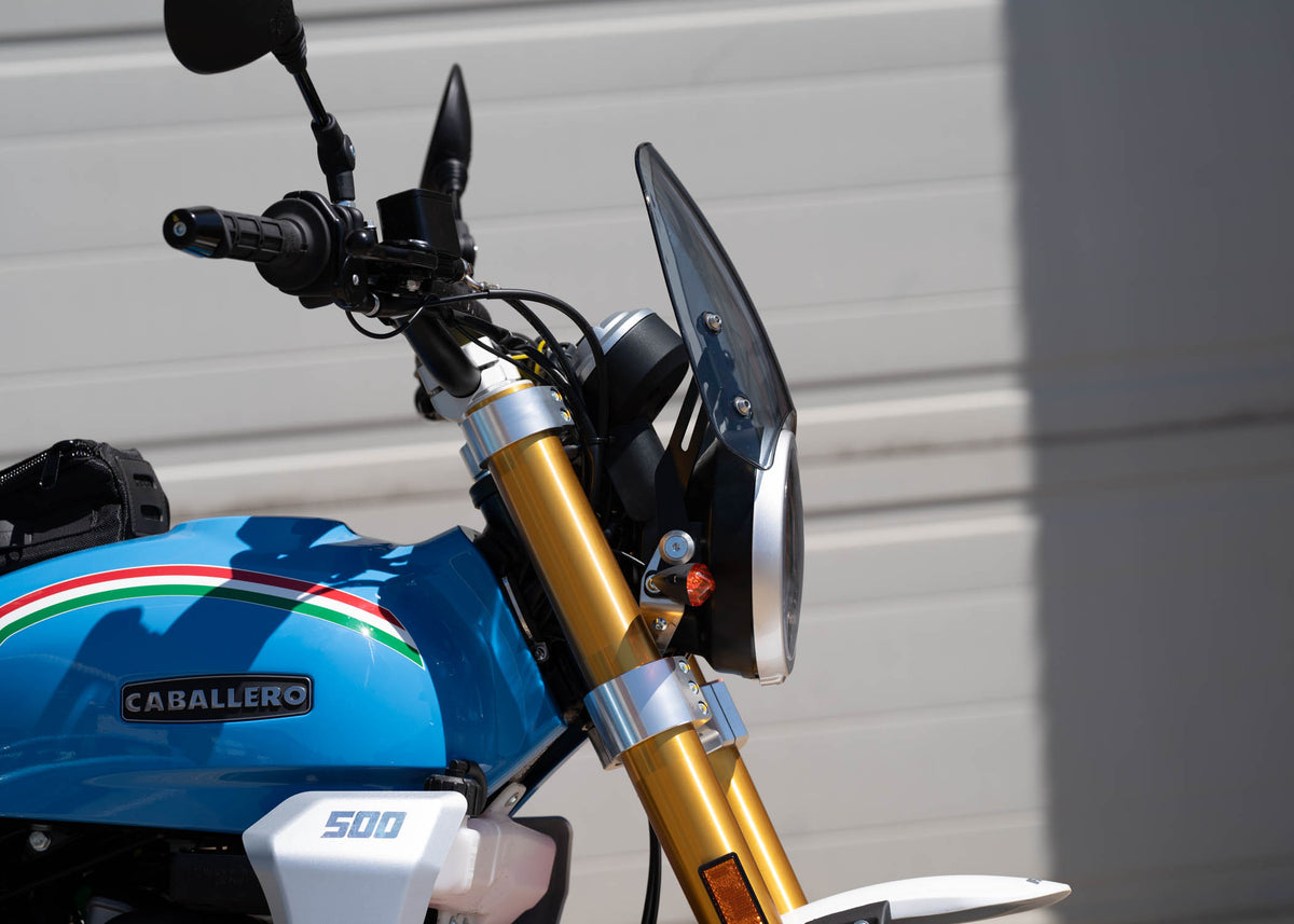 Close up of a Fantic Caballero in blue with a dark tinted Dart Flyscreen
