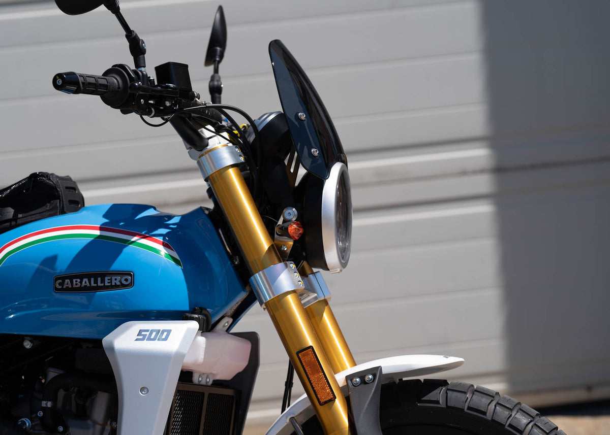 Close up of a Fantic Caballero in blue with a dark tinted Dart Flyscreen
